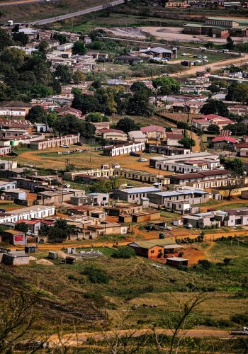Aerial view of a traditional village and community infrastructure representing socio-economic development and local employment verification.