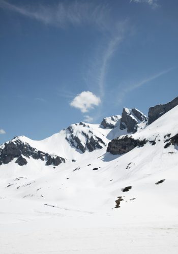 Panoramic view of snow-capped mountain peaks representing high-altitude environmental sensitivity and verified low-carbon building performance data.
